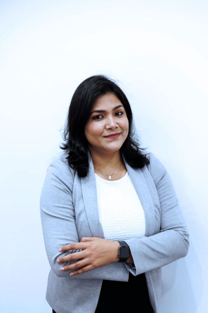 A woman in a grey suit and white shirt understands how to maintain good relations.